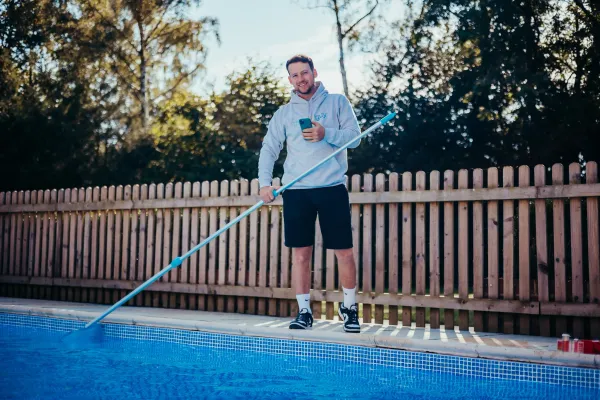 Miles Laflin, aka @thep00lguy, cleaning a pool